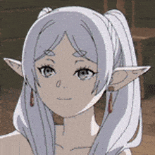 a close up of a cartoon character with long white hair and ears .