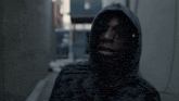 a man wearing a hooded sweatshirt with the word adidas on it