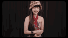 a woman wearing a leopard print hat and a red scarf is making a face