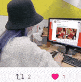 a woman with blue hair is sitting in front of a computer screen with a tweet from lover