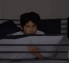 a man laying on a bed with a pillow and a glow in the dark exclamation point behind him