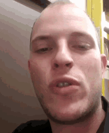 a close up of a man 's face with his eyes closed