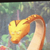 a close up of a cartoon snake with the letter o on it 's neck