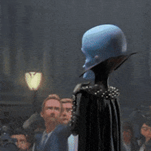 a cartoon character stands in front of a group of people