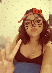 a girl wearing glasses and a hello kitty face mask