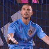 a man wearing a blue shirt that says herbalife