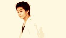 a young woman in a white shirt is pointing at something .