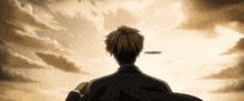 a man in a suit stands in front of a cloudy sky