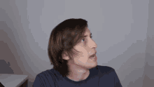 a man with long hair is looking up at the sky
