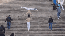 a man is doing a handstand on the stairs
