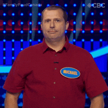 a man in a red shirt with a name tag that says michael says yup