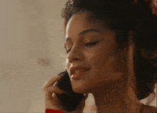 a close up of a woman talking on a phone