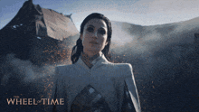 a poster for the wheel of time shows a woman holding a book