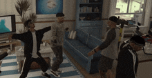 a group of men dancing in a living room with a blue couch