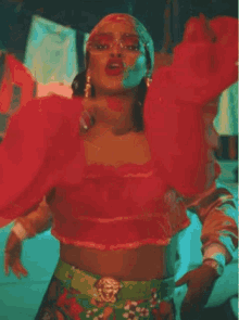 a woman wearing sunglasses and a head scarf is singing .