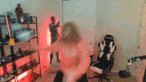 a blurred image of a person standing in a room with a chair that says g-force