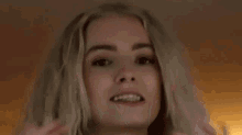 a woman is holding her hands up in the air .