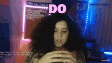 a woman says " do " in front of a happy halloween sign