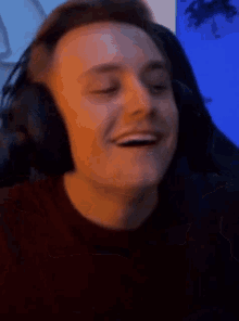 a man wearing headphones is giving a thumbs up sign