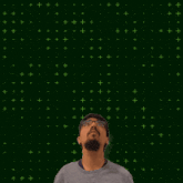 a man stands in front of a green background with the number 15