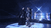 two women are standing in a ring with the word wow on the wall