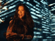 a woman with long hair is smiling in front of a blurry background with the hashtag njfaerie