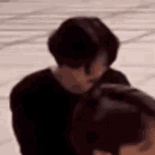 a blurry picture of a man standing next to a woman .