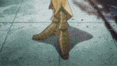 a close up of a person 's feet in a pair of gold boots