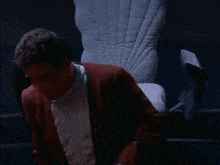 a man is sitting in a chair with the words by grabthar 's hammer you behind him