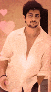 a man wearing a white shirt has a necklace around his neck