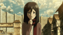 a girl with a scarf around her neck is standing in front of a building