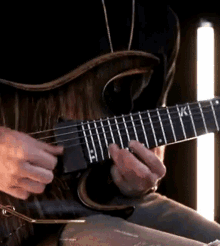 a man is playing a guitar with the letters vki on it