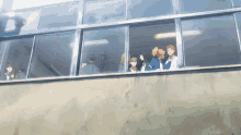 a group of people are looking out a window