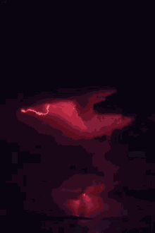 a red lightning bolt strikes the ground in a dark cloudy sky