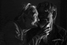 a black and white photo of a woman kissing a man 's cheek