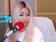 a woman is sitting in front of a microphone .