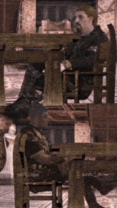 a man sits at a table in a video game with the name seth_a on the bottom