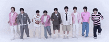 a group of young men are standing in a row and one of them is wearing a jersey with the number 20