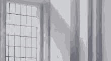 a white room with a window and a pillar .