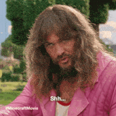 a man with long hair and a beard says " shh "