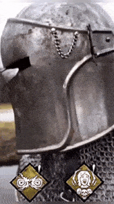 a close up of a knight 's helmet with skulls on it