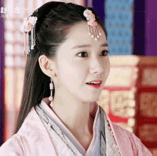 a girl wearing a pink kimono and a headpiece with the date 28-29 on it