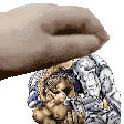 a hand is holding a statue of a man in a suit on a white background .