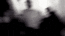 a blurred image of a person 's face in a dark room