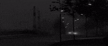 a truck and a car are driving down a road at night .