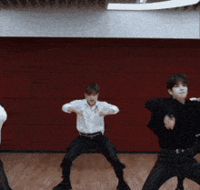 a group of young men are dancing in a dance studio