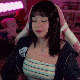 a girl sitting in a pink chair with her eyes closed and the letters ig on the bottom