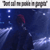 a man wearing a red beanie says " dont call me pookie im gangsta " while standing in front of a stage