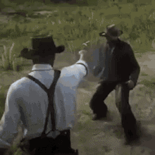a man in a cowboy hat and suspenders is standing in a field with a gun .