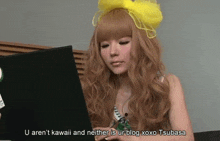 a woman with a yellow bow on her head is using a laptop computer